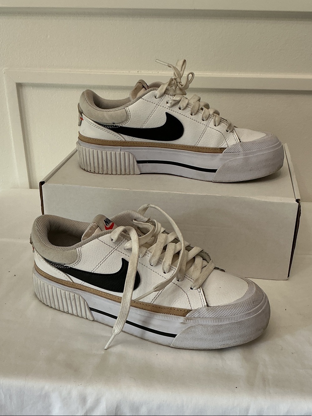 Nike White Low-Top Sneakers with Black Swoosh and Tan Accent